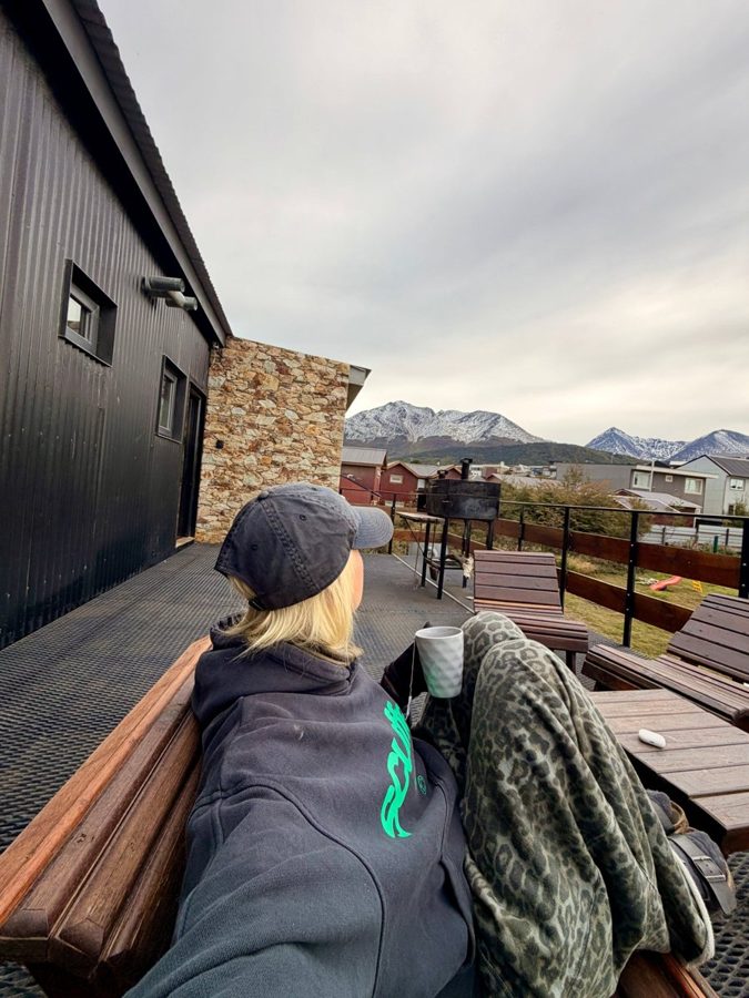 Tea on a cabin terrace facing snowy mountains